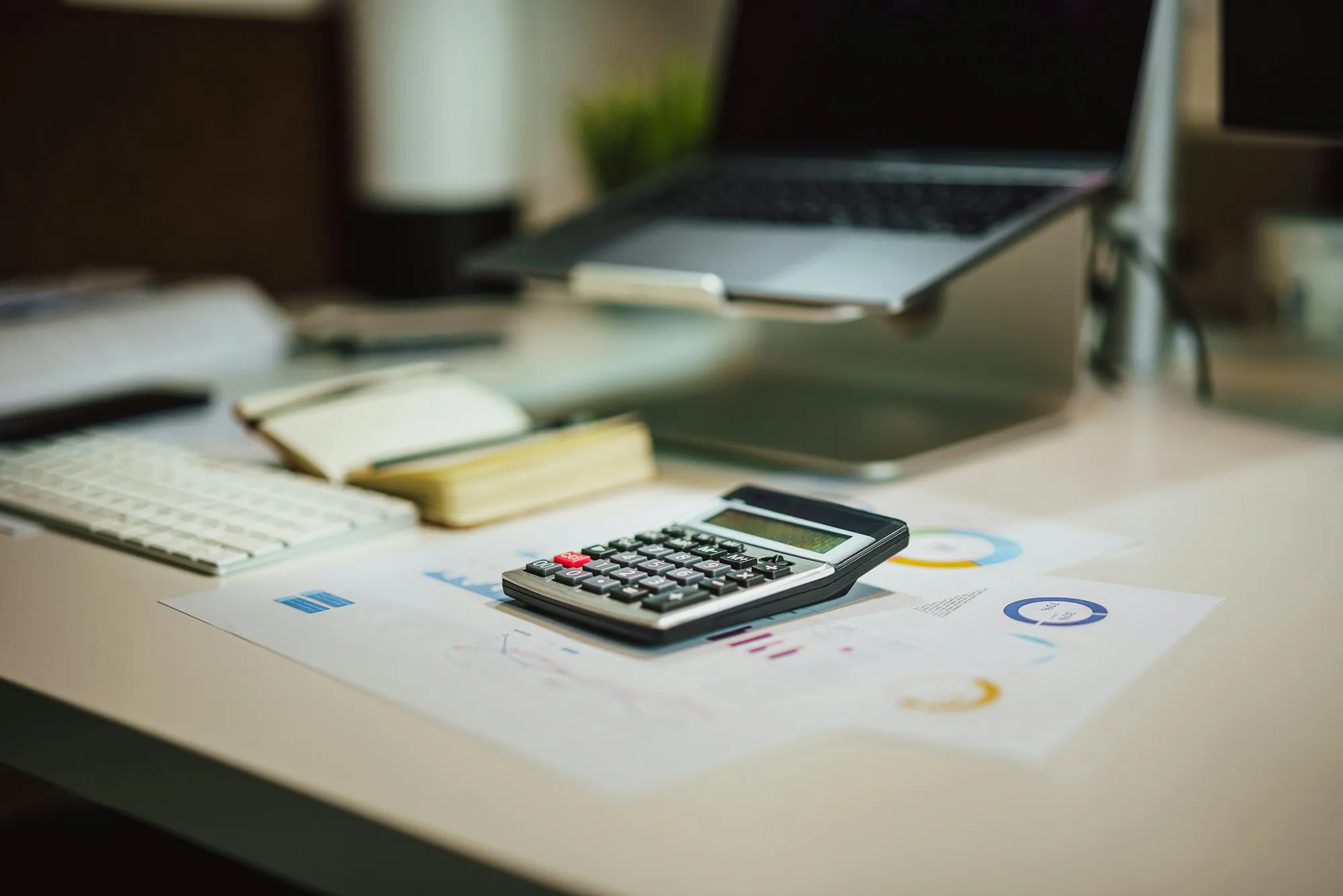 Accountant's desk with calculator and reports